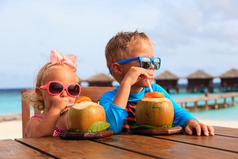 family-travel-kids-drinking-coconuts
