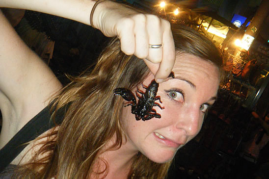 Sampling the local speciality of fried Scorpion in Backpacker central: Khao San Road, Thailand 