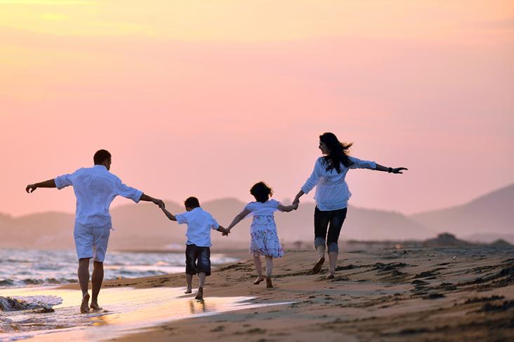Family running down the beach
